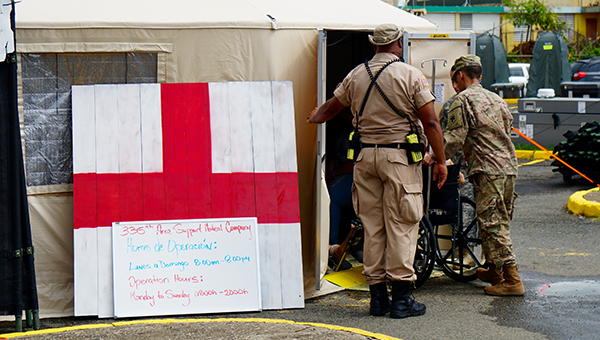 Patient in wheelchair entering medical tent