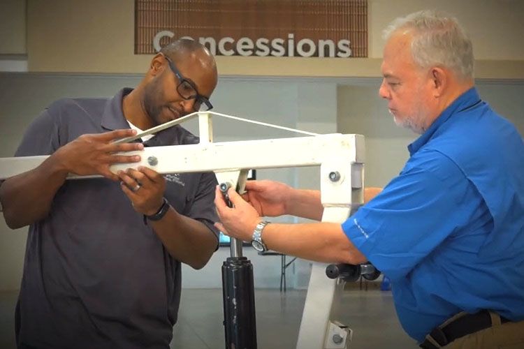 two men handling a bariatric lift