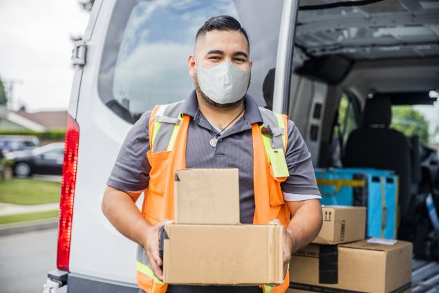 Young Male Hispanic Delivery Man Takes Package to Home Wearing a Face Mask