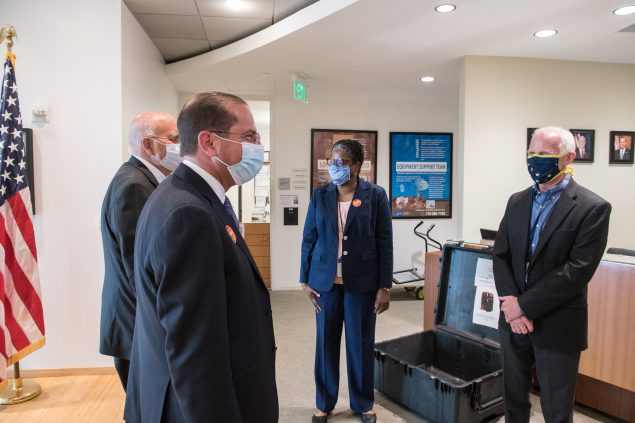The photo shows four people in a CDC reception area wearing masks and looking at each other. Leandris Liburd, in the middle, is CDC’s chief health equity officer. She is seen here with - from left to right - CDC director Dr. Robert Redfield, Alex Azar, Secretary of Health and Human Services, and Dr. Jay Butler, CDC’s deputy director for infectious diseases.