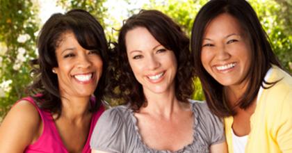 three women of different ethnicity, smiling