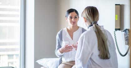 Woman discussing prenatal screening with a doctor.