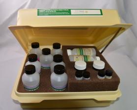 color photograph of test kit bottles in off-white plastic box 