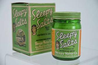 small glass bottle and box of Sleepy Salts product