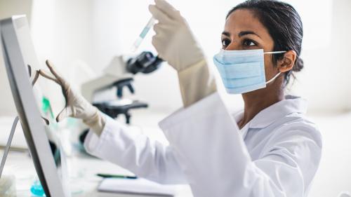 Scientist holding test tube - Catalog of Regulatory Science Tools