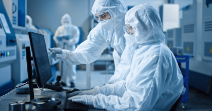 Scientists in a lab working at a computer