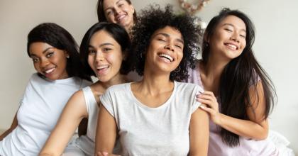 Group of diverse young women smiling happily
