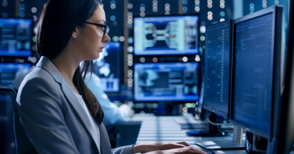 Employee typing while staring at a computer screen.