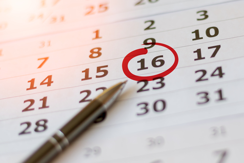 Calendar closeup with date circled and pen