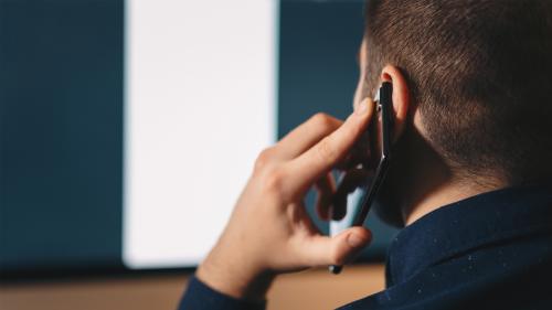 Man holding cell phone to his ear. Do Cell Phones Pose a Health Hazard?