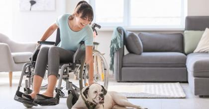 woman in a wheelchair with a service dog