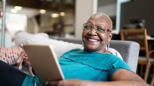 Image of a woman holding a smart tablet.