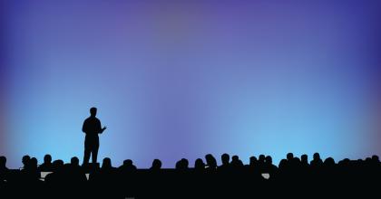 Speaker standing up in front of audience