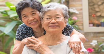 Portrait of Asian female older ageing women smiling with happiness in garden