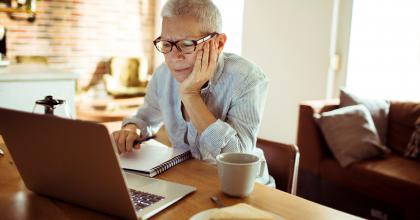 A person reading information on the computer.