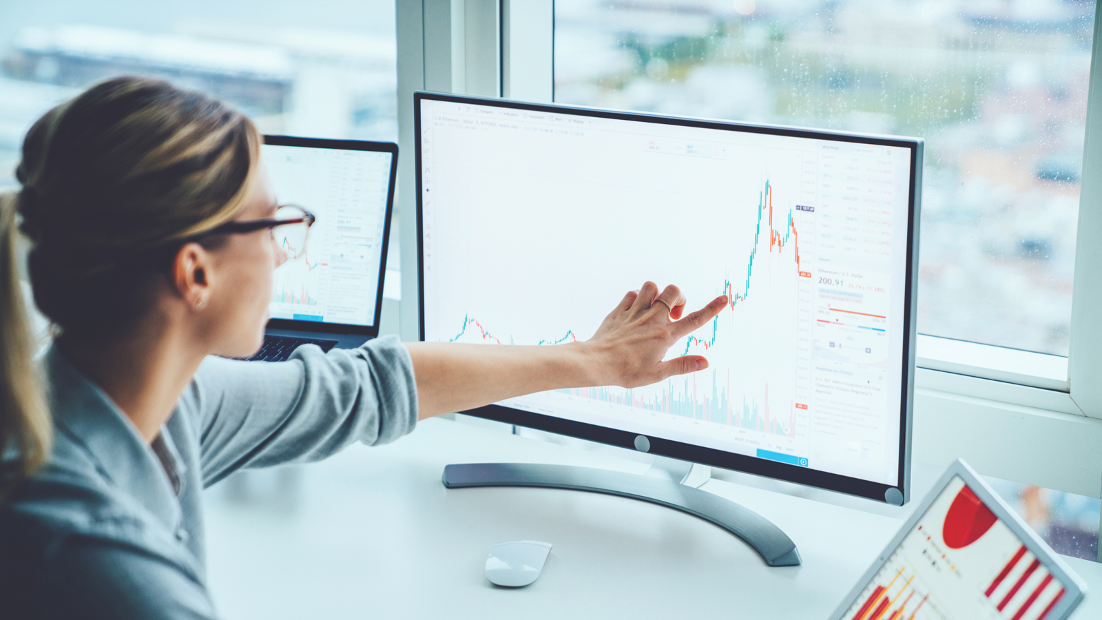 Women pointing at figure on monitor screen