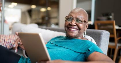 Image of a woman holding a smart tablet.