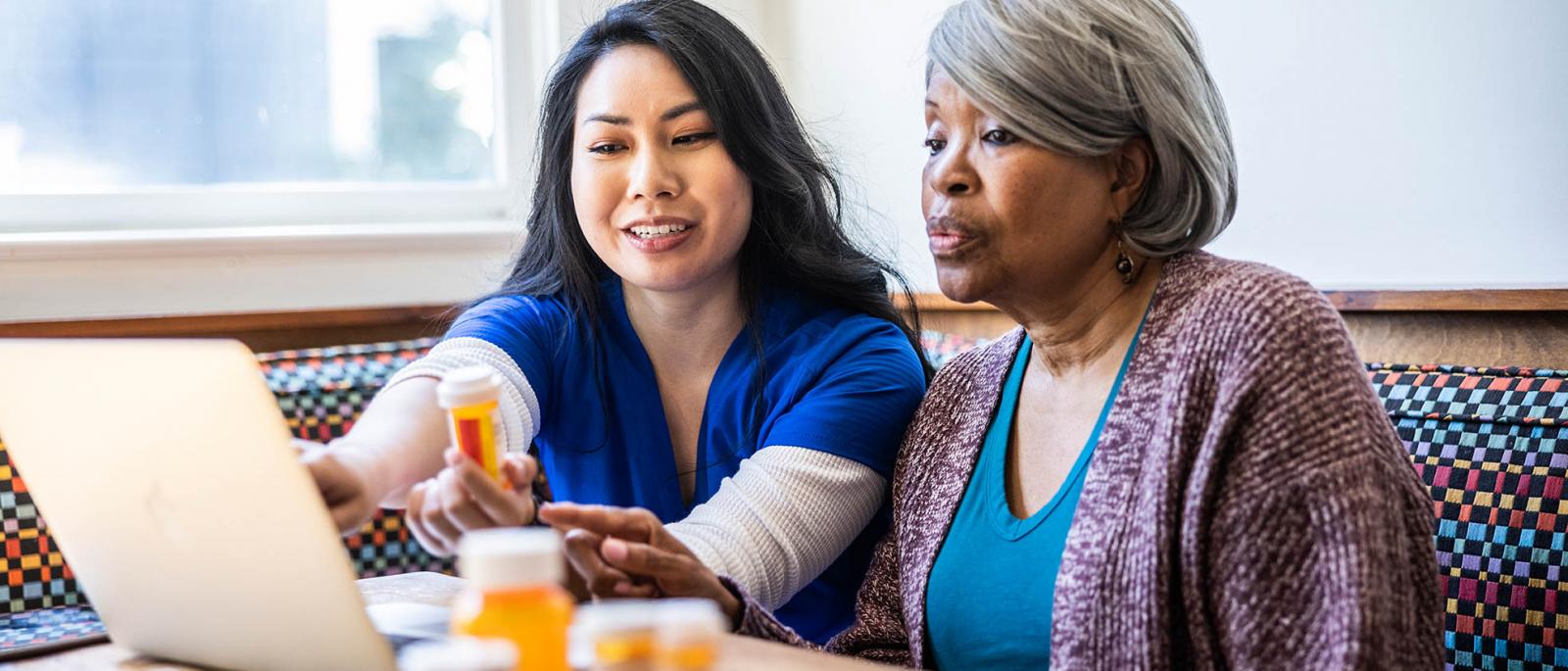 Nurse reviewing medication with older lady.