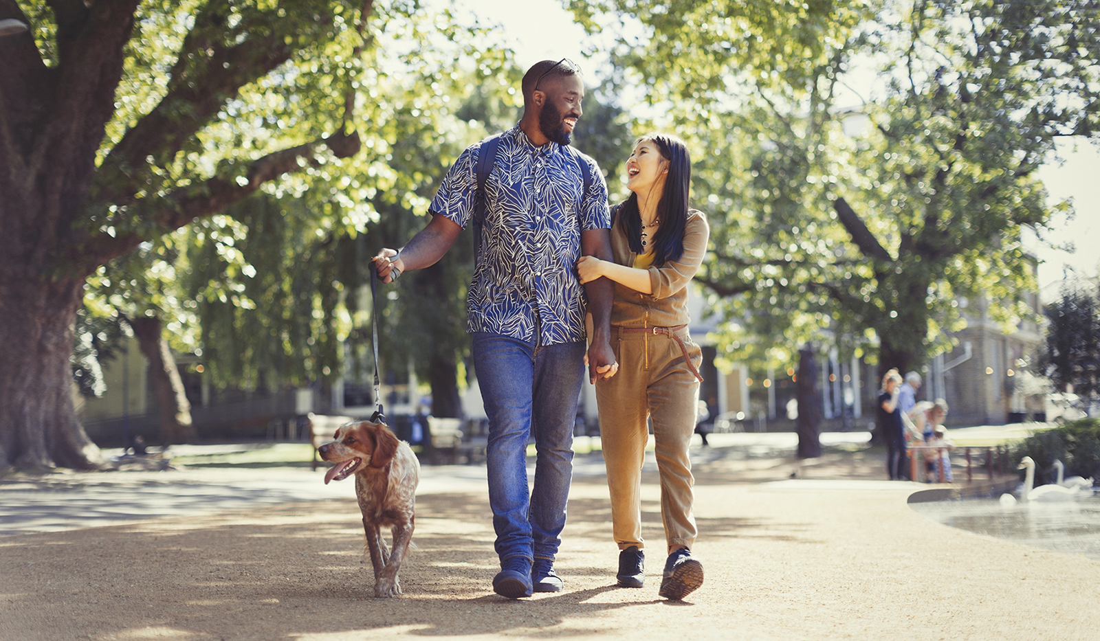 Man and woman walking a dog