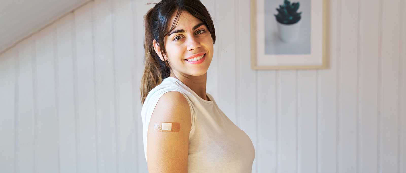 Woman with small bandage on arm.