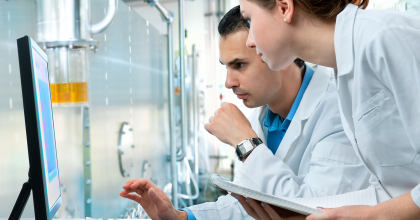 Scientists analyzing data on a computer