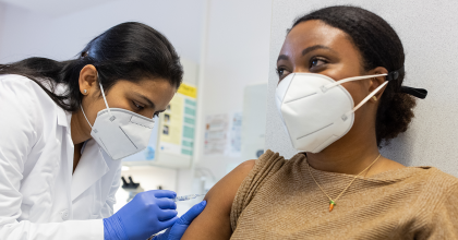 Doctor administering shot to patient