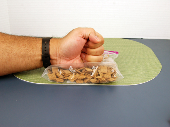 Cereal in bag being crushed with fist