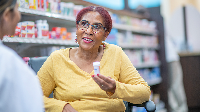 woman holding bottle of medicine