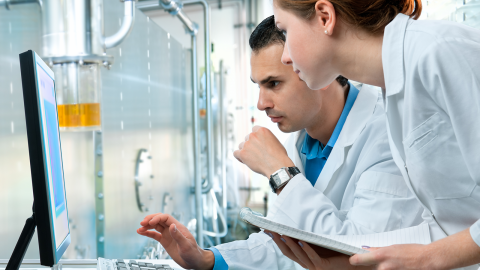 Scientists analyzing data on a computer