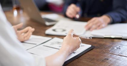 Co-workers writing at a desk