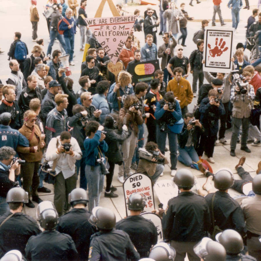 Photographers documenting a crowd of people outside FDA headquarters protesting the agency's lack of action in response to HIV/AIDS epidemic in 1988.