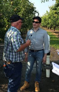 FDA Commissioner Scott Gottlieb, right, talks with farmer Gary Willis in Hood River, Oregon.