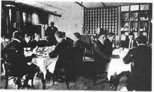 Several men sitting at two tables  