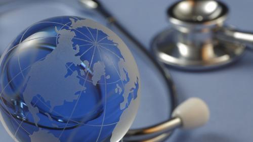 A photo of a globe and a stethoscope