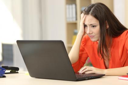 Unhappy woman looking at the computer