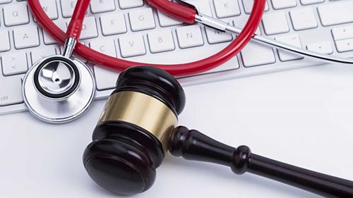 Laptop, gavel, and stethoscope, representing online resources