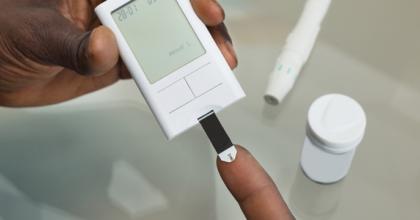 Testing blood on finger with glucose meter