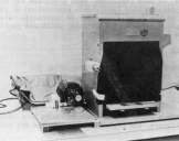 Waco Saw for sectioning, to left, and seam projector for examining cross sections of double seams, to right in photograph