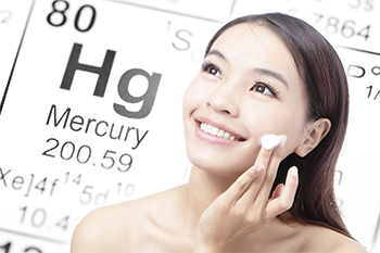 Woman putting on skin cream with mercury element in the background