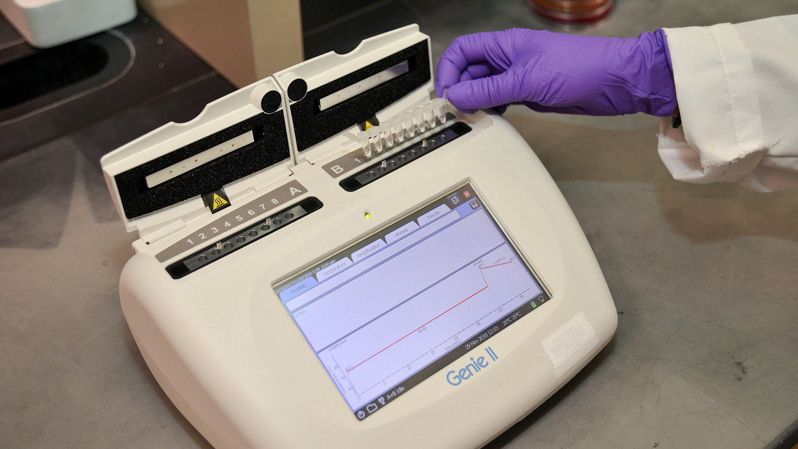 A scientist tests a group of samples using a piece of scientific equipment.