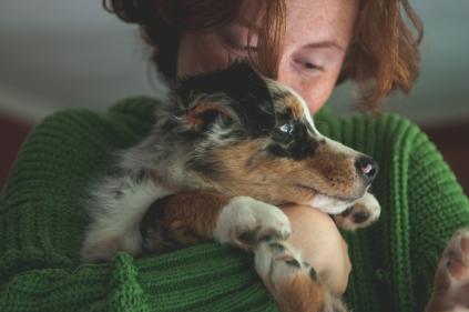 Photo of a woman hugging a dog.
