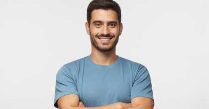 Smiling man standing with arms crossed