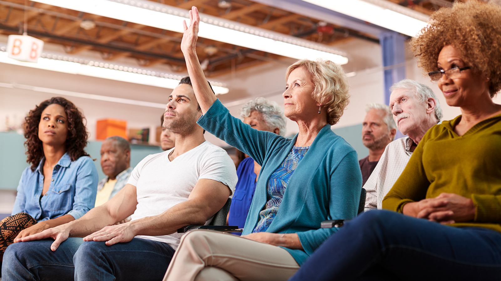 Woman asking question at meeting