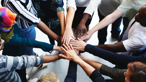 Group of people with hands in the middle