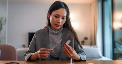 Woman using at home COVID-19 Antigen Test