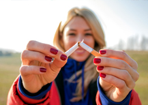 Woman breaking a cigarette