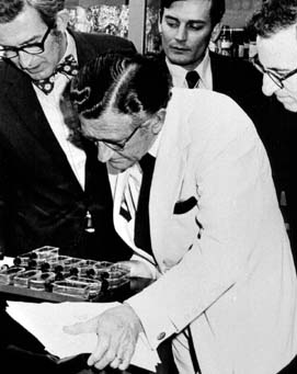 Rep. L.H. Fountain and three other men examining a group of laboratory dishes