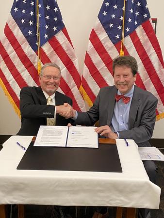 New York State Department of Agriculture and Markets Commissioner Richard Ball and FDA Commissioner Robert Califf sign