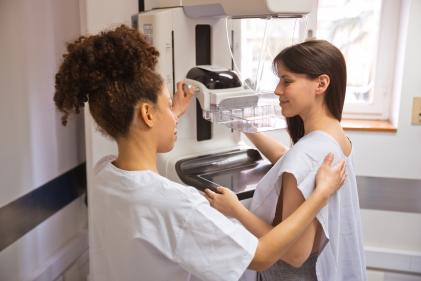 Female doctor talking to patient during Mammography 