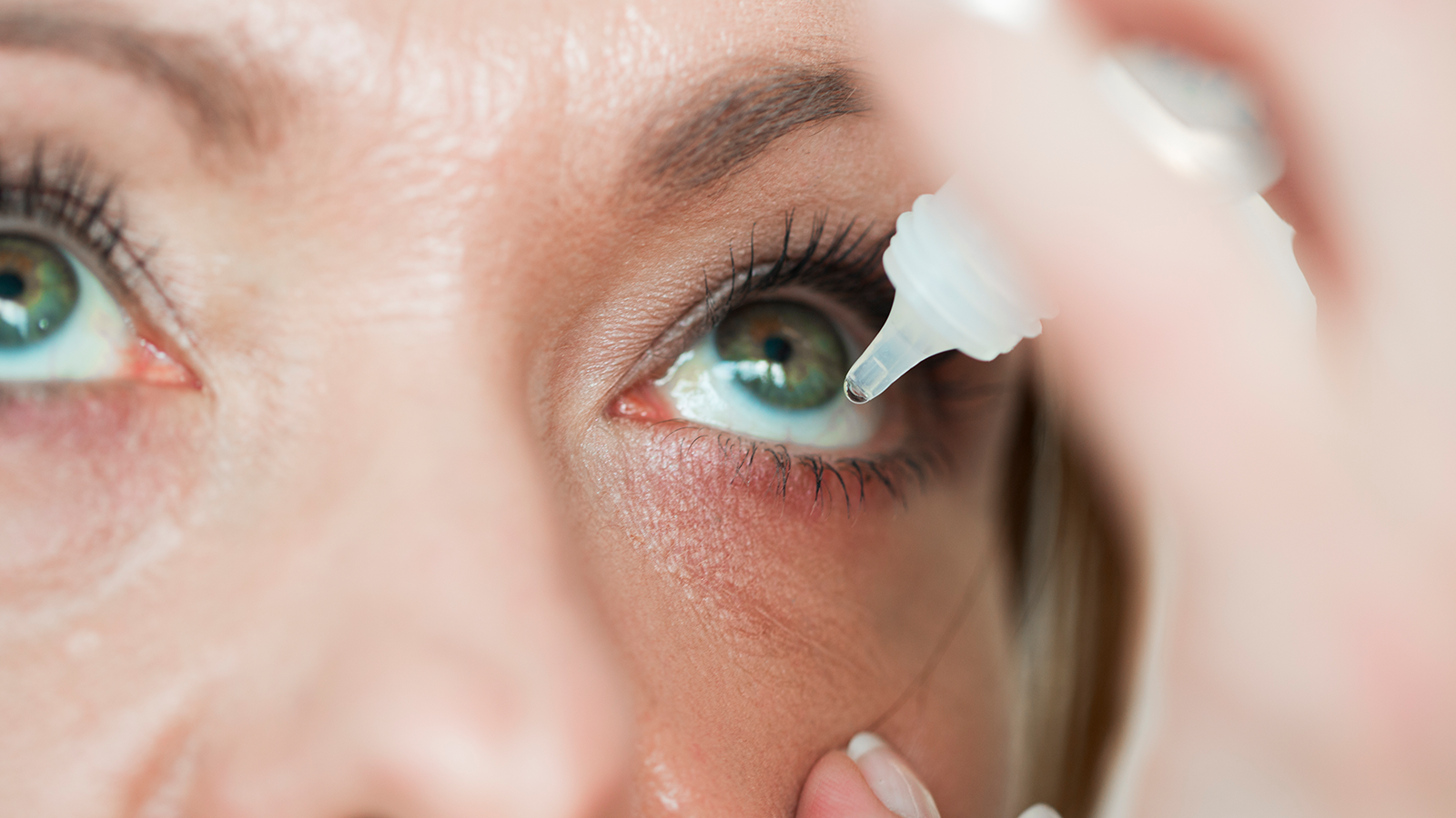 Woman using eye drops